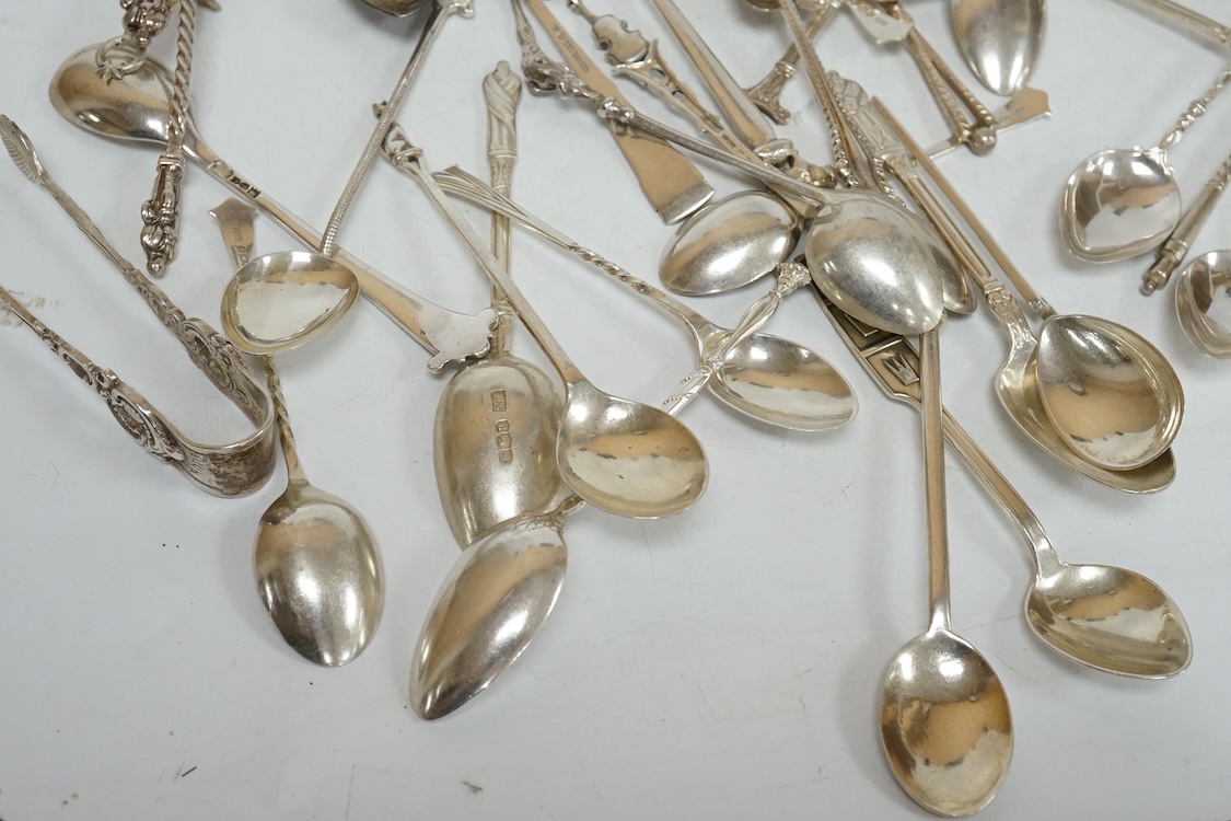 A group of assorted silver and white metal tea and coffee spoons and a pair of silver sugar tongs, weighable hallmarked silver 8.6oz.